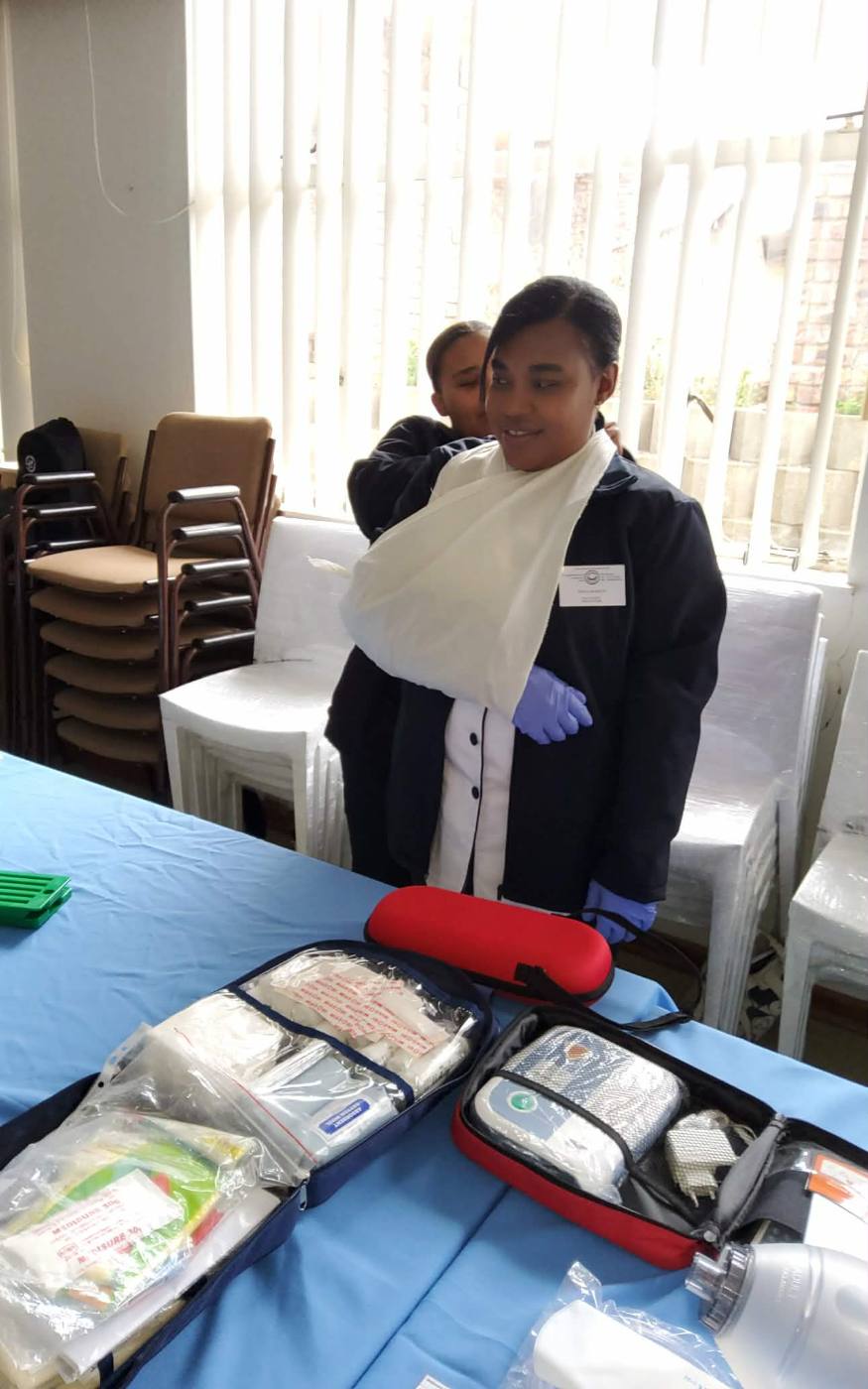 Student practising arm sling bandaging technique