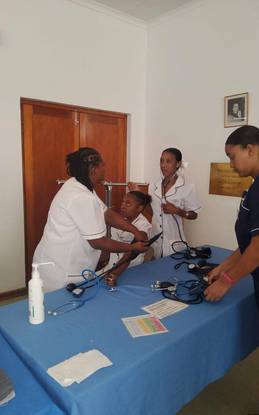 Students practising blood pressure and stethoscope use