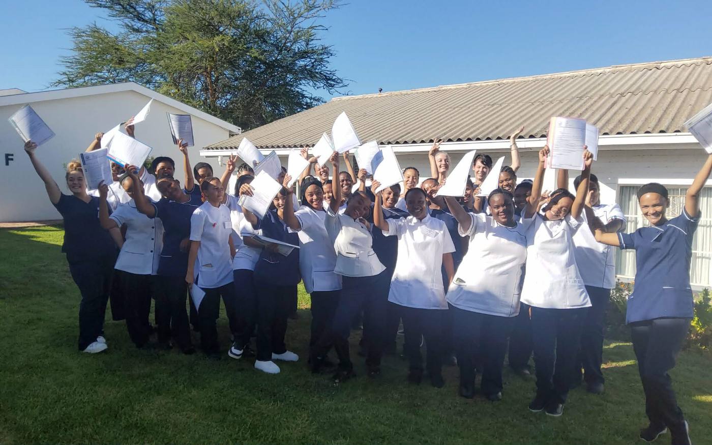 Graduating class group photo with certificates