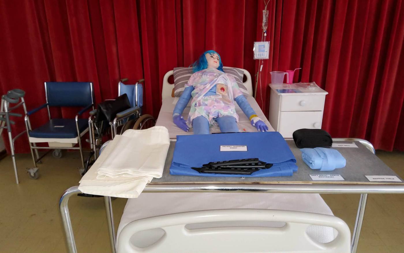 Patient care manikin set up in a hospital bed